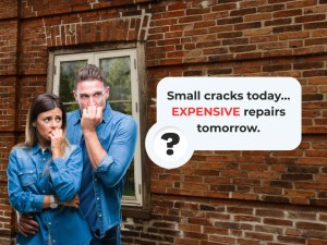 Worried homeowners in front of a damaged brick wall, showing what-happens -f-you-don’t-tuckpoint and how small cracks can lead to expensive repairs.